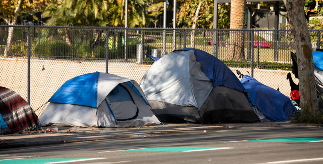A row of small tents on the side of a street.