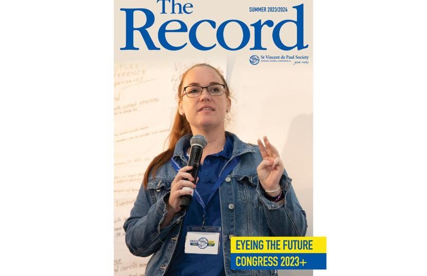The cover of a magazine called The Record with a picture of a young woman holding a microphone.