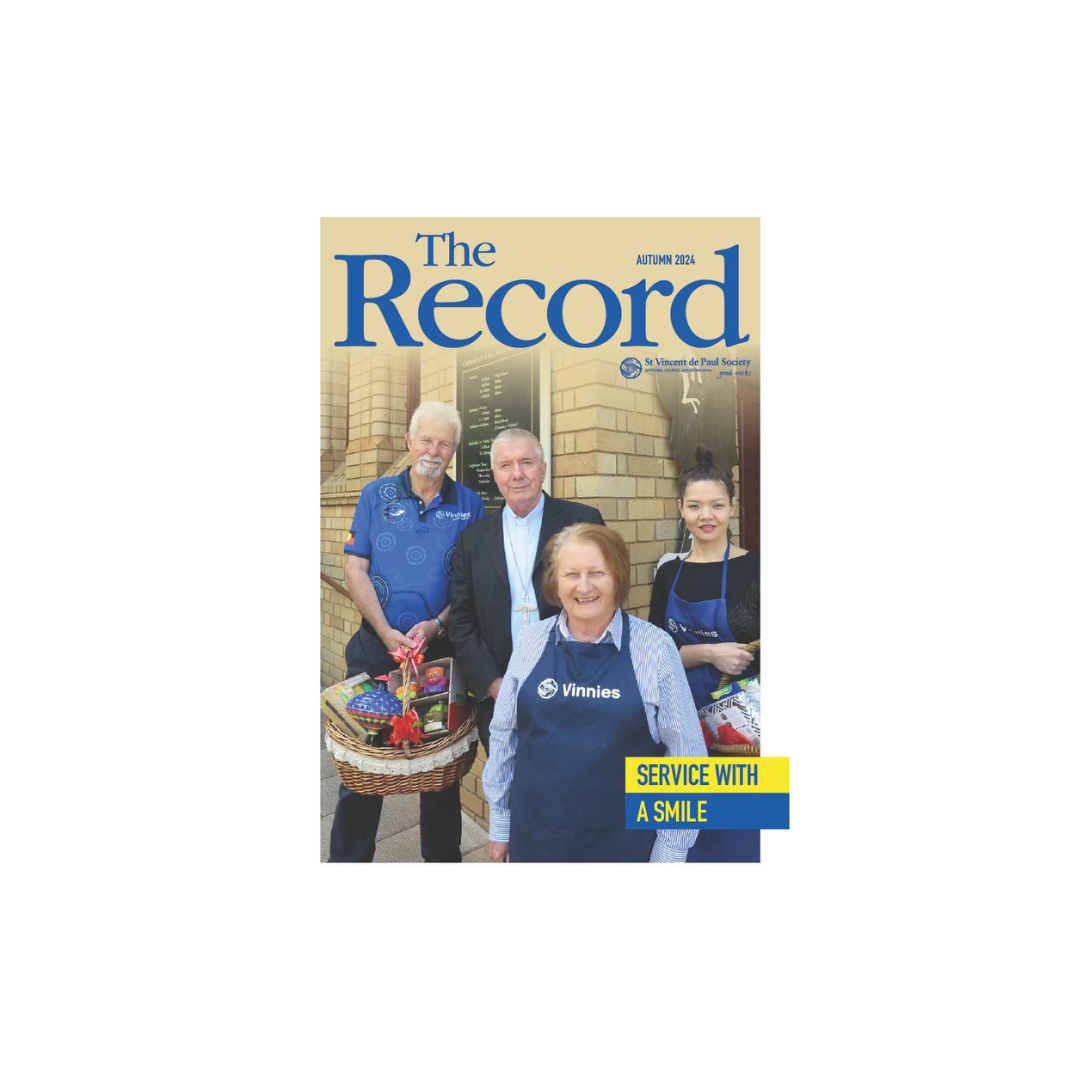 Cover of The Record showing title and edition info and a picture of 4 people, one holding a hamper and facing the camera.