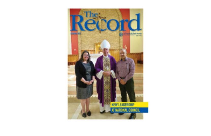 Cover of The Record showing title and edition info and a picture of 3 people in a Church facing the camera.