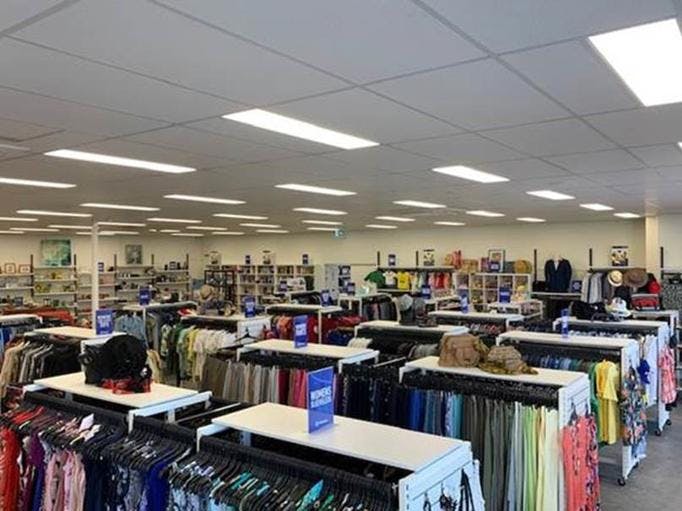 A photo of the inside of the Vinnies Shop Australind, showing neatly placed clothing racks containing second hand clothes.