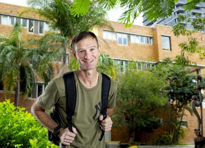 Vinnies Companion, James, standing with backpack on campus