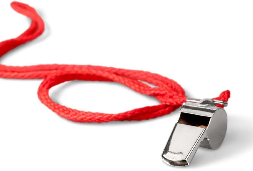 A photo of a sport whistle on a red cord on a white background.