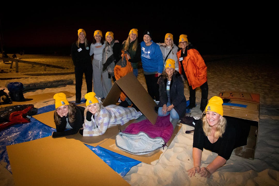 CEO's and leaders sleeping on cardboard on the beach at the CEO Sleepout event
