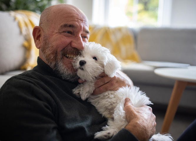 ex-prisoner hugging his puppy in home