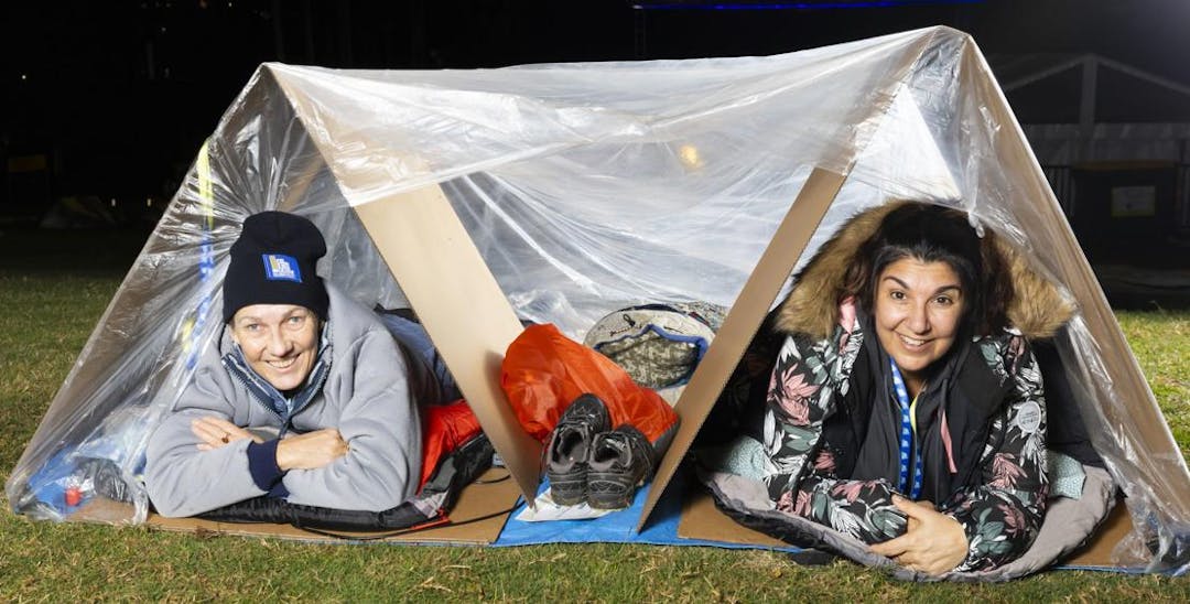 Vinnies CEO Sleepout participants in cardboard shelter and plastic sheet