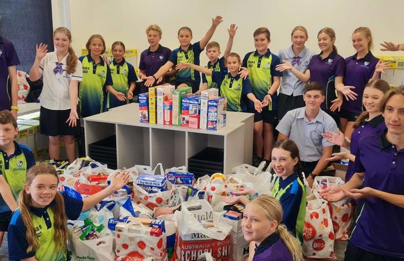 Helen Nambour Schools standing with food donations